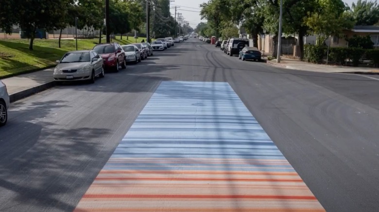 Red and blue painted stripes in middle of asphalt road Pacoima