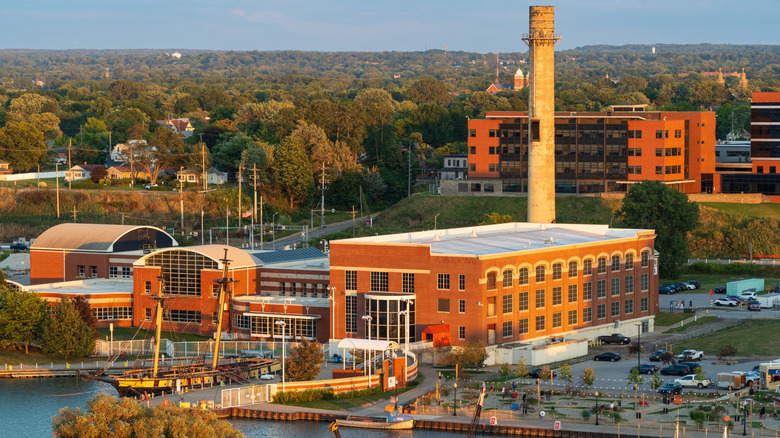 Industrial building with tower, ship in foreground