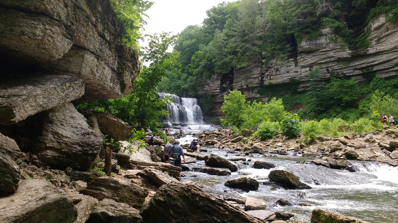 Hikers near the waterfall at Cummins Falls State Park, Tennessee