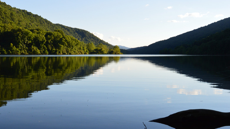 Lake Moomaw in Virginia with still water reflecting forest covered mountains on both sides