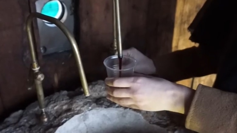 Pouring wine from the free fountain at Dora Sarchese Vineyard