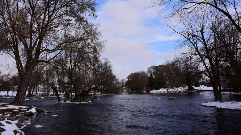 The Fox River in Waterford, Wisconsin, in the middle of autumn with snow on the banks