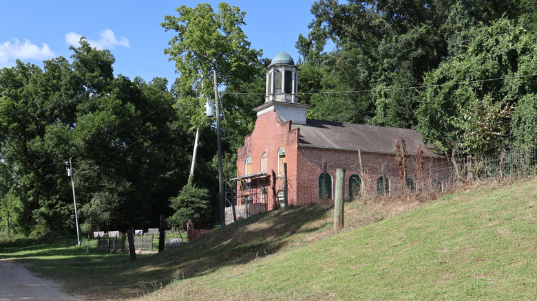 A side view from the street of the abandoned Rodney Presbyterian Church with scaffolding