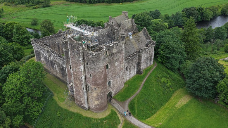 Aerial view of Doune Castle on a lush green hill