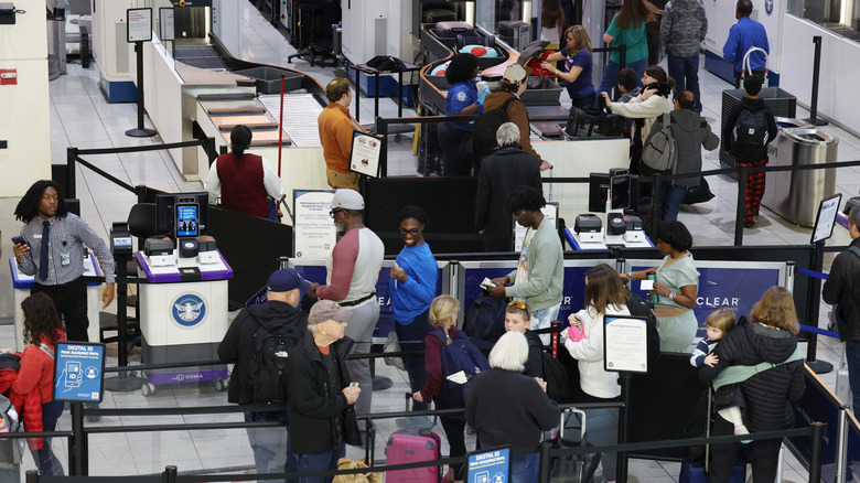 Travelers wait in line for security at the Baltimore Washington International airport