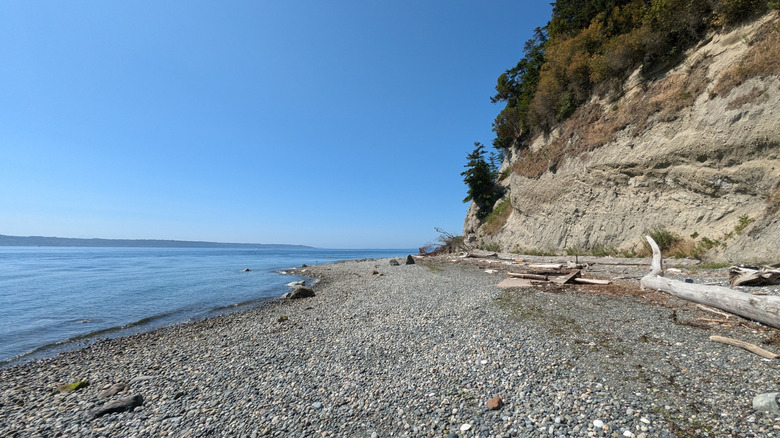 Pebbly beach framed by bluff at Possession Point State Park in Washington