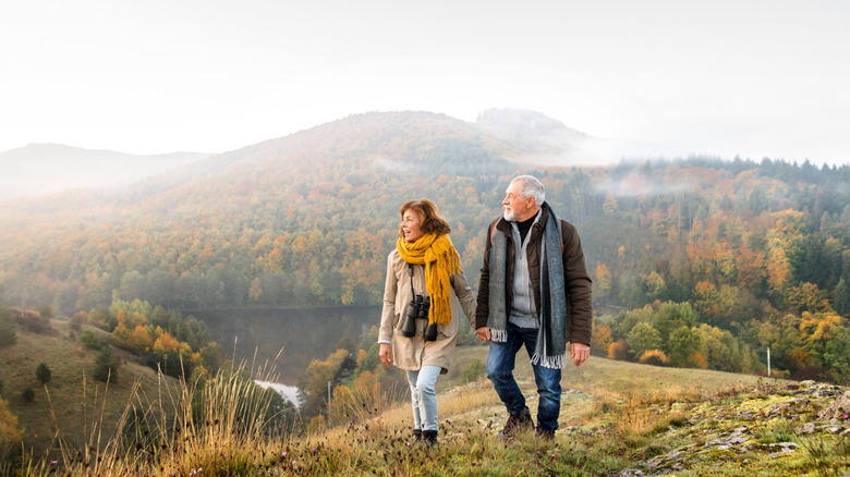 Elderly couple hiking in the fall season