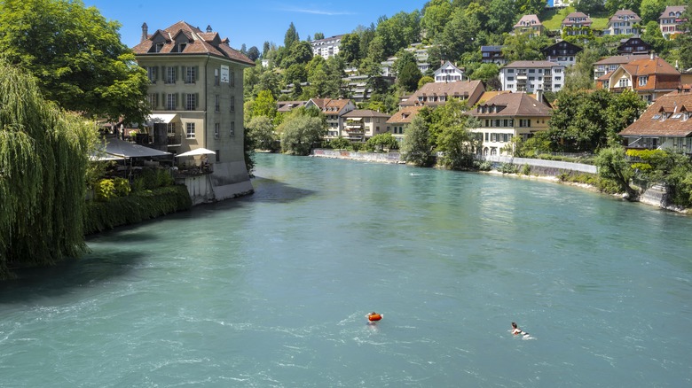 swimmer and tuber in Swiss river flowing through city