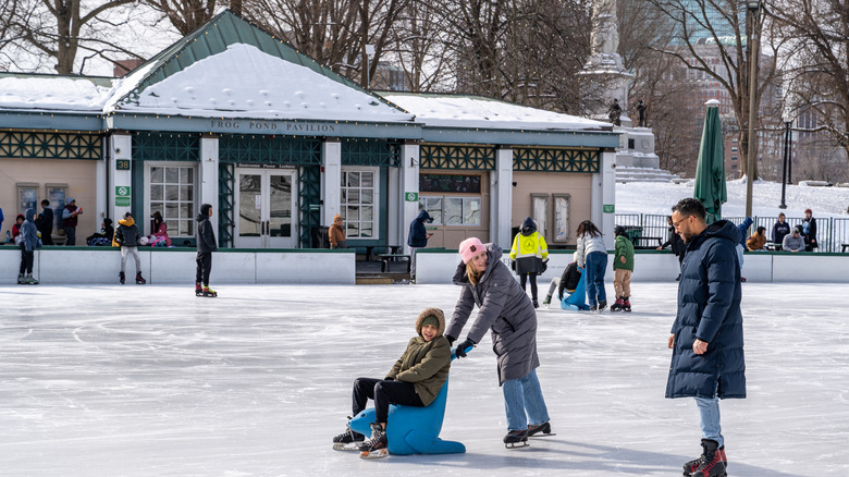 A family skating on the Frog Pond Skating Rink in Boston, MA