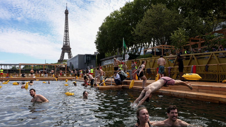 People swimming in the Seine with the Eiffel Tower in the background