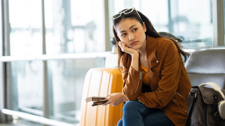 Woman looking unhappy at the airport
