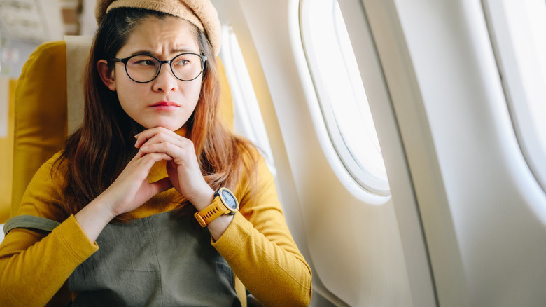 Nervous traveler sitting in an airplane
