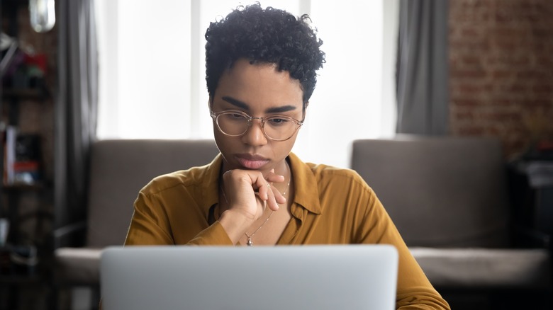 Pensive woman on computer 