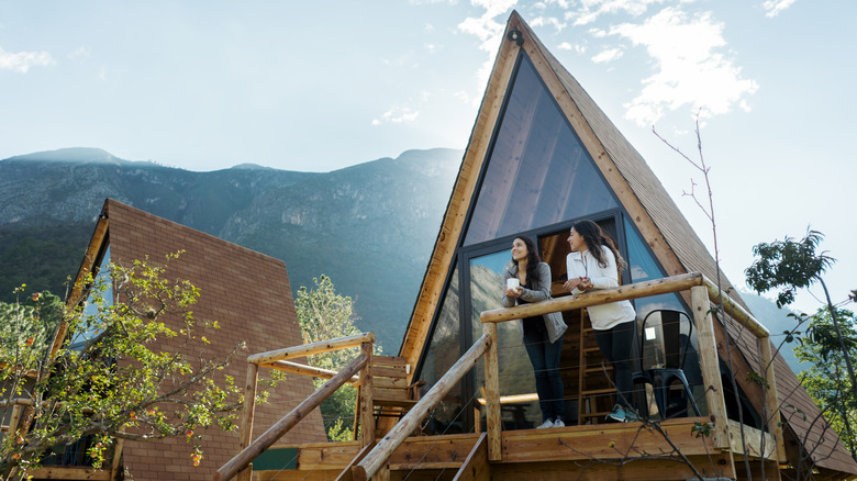 Women at cabin with mountains