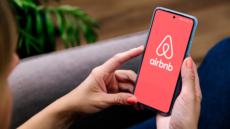 Airbnb app displayed on smartphone screen with logo