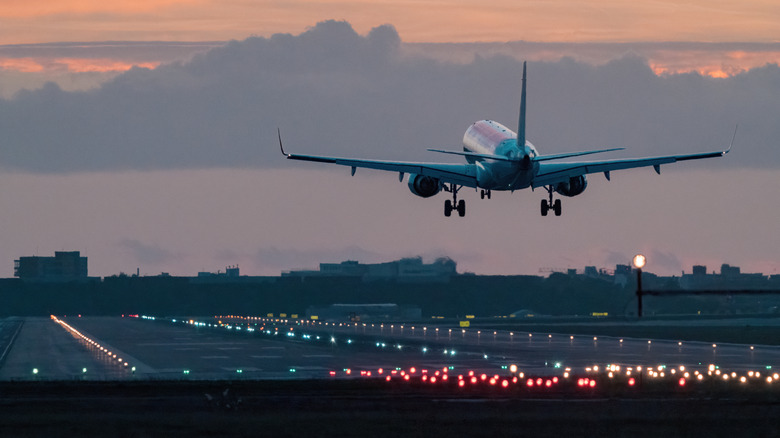 Plane taking off at sunrise