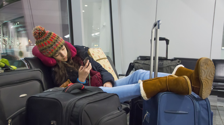 Girl with neck pillow overpacked