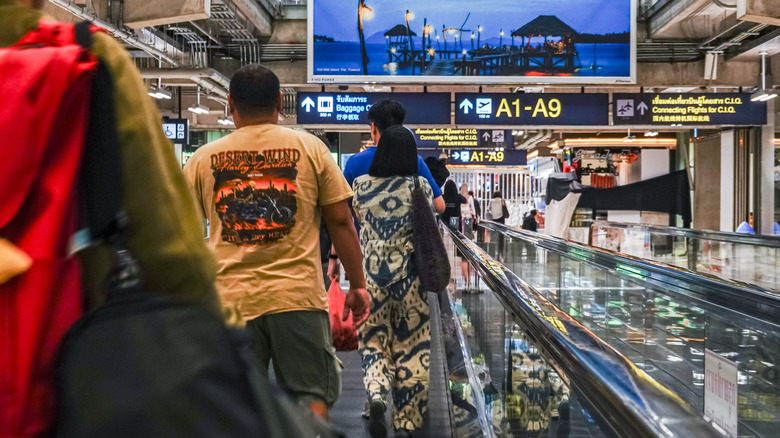 People walking on travelator in airport