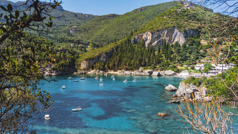View of Liapades Bay from the water looking towards the cliffs of Akrotiri Beach Resort on Corfu, Greece