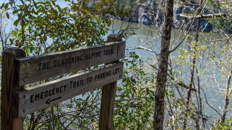 Sign for The Deadening Alpine Trail in Dadeville, Alabama with views of Lake Martin in the background