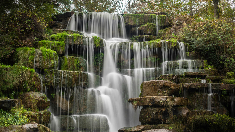 Waterfall cascading over rock ledges at Spring Park in Tuscumbia, Alabama