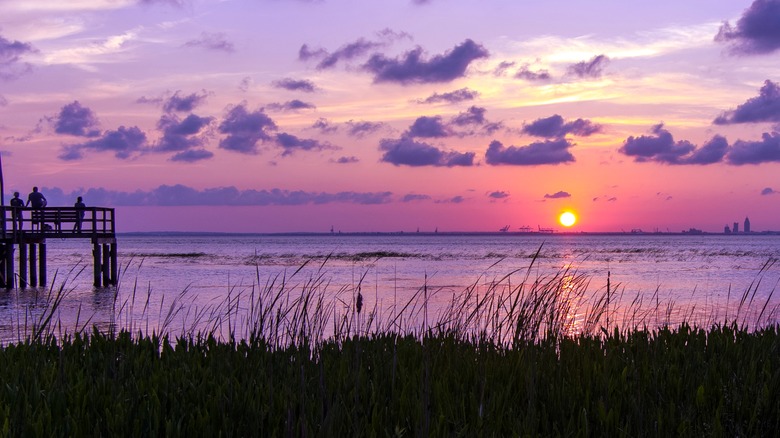 The sun sets over Mobile Bay from the shores of Daphne, Alabama