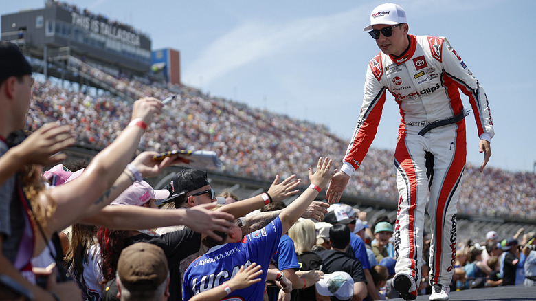 A driver and fans at Talladega Superspeedway