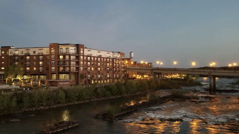 The Chattahoochee River bank and a hotel building during sunset.