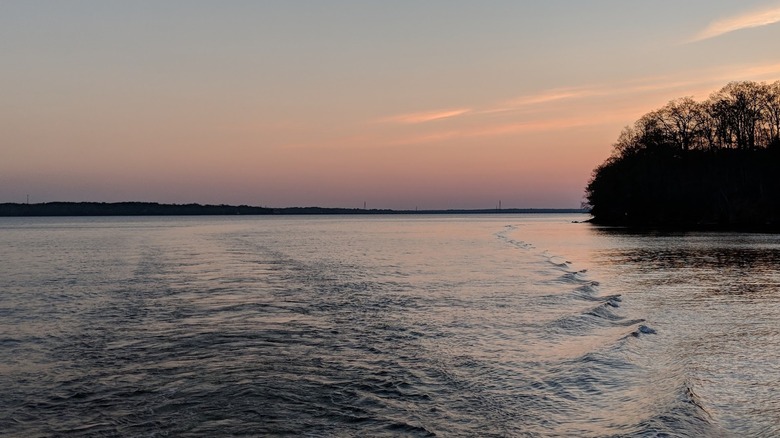Gentle waves formed by a boat on Wheeler Lake at Joe Wheeler State Park, Alabama, after sunset