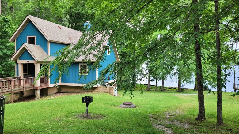 Blue lakeside cabin surrounded by trees at Joe Wheeler State Park, Alabama
