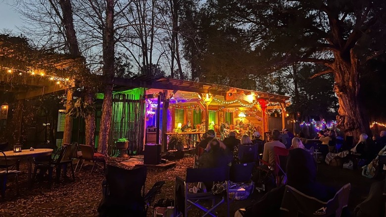 The Frog Pond porch with multicolor lights and crowd of people