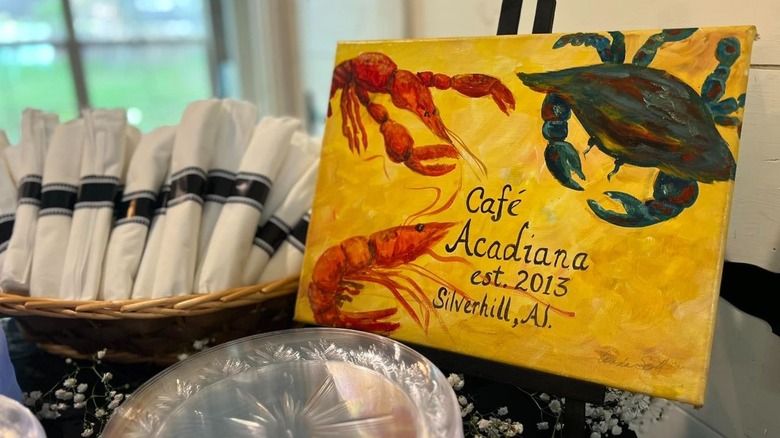 Food dishes with a yellow sign for Café Acadiana