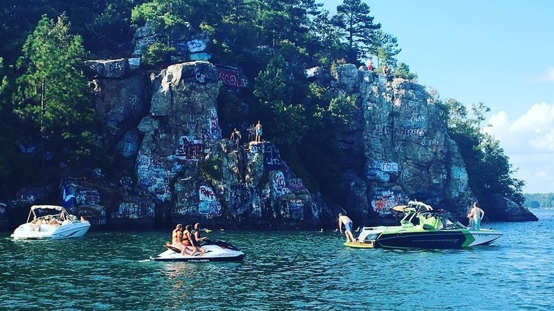 Boats and jet skis on a lake by Chimney Rock