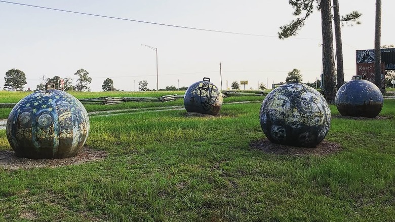 Large balls sitting in green grass