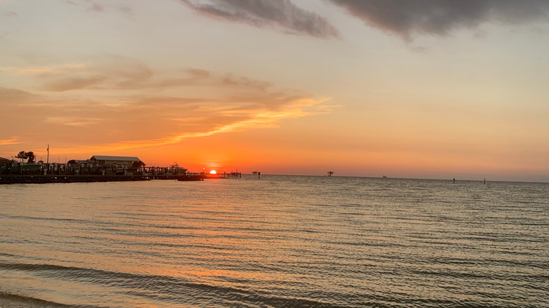 Sunset over docks in the Mobile Bay in Fort Morga, AL.