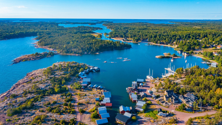 A drone view of Käringsund in the Aland Islands, Finland, with the sea, green forests, boats, and the village