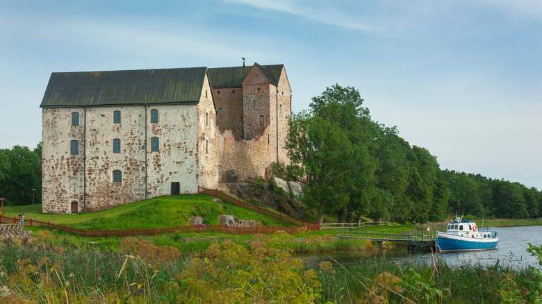 Kastelholm medieval castle overlooking a lake and boat