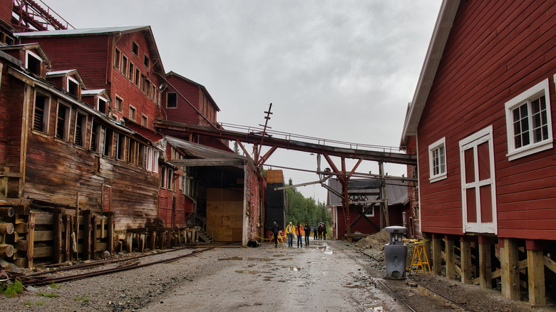 Muddy roads pass through abandoned mine buildings in Kennecott, Alaska