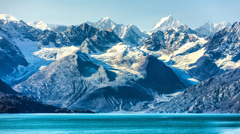 Jagged snow-capped mountains next to the sea