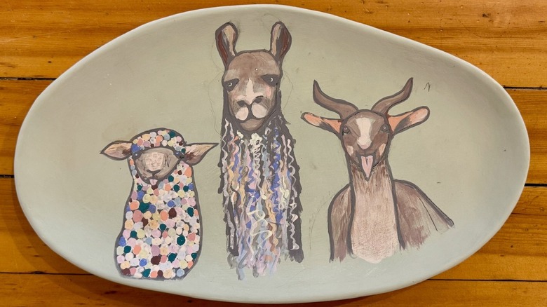 Unfired plate artwork adorned with farm animals