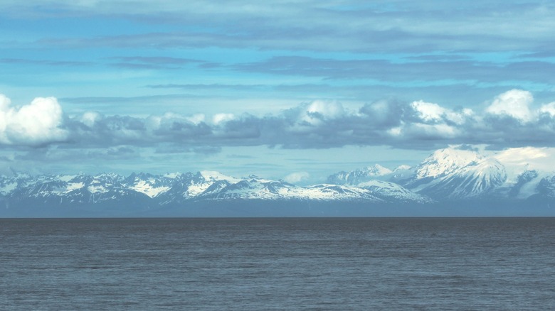 Body of water and snow-capped mountains