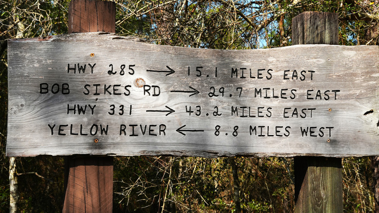 Florida National Scenic Trail wooden mileage marker sign near Elgin Air Force Base