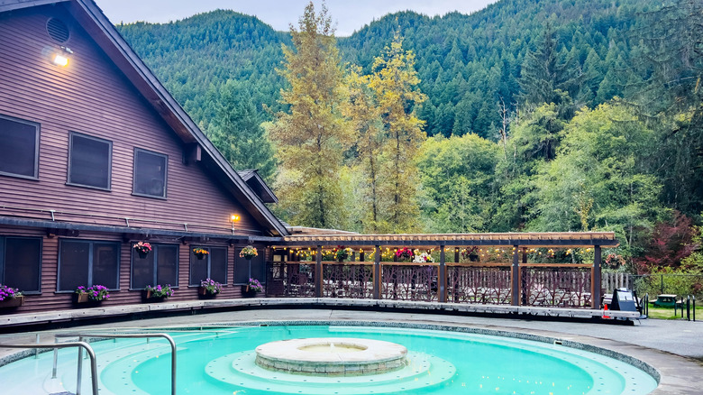 A large, outdoor pool fed by mineral water with a lodge at Sol Duc Hot Springs Resort in Washington.