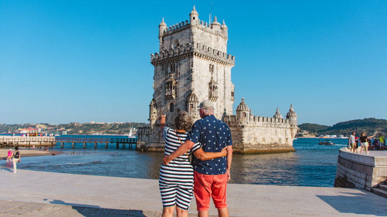 Elderly couple gazing at Portuguese architecture