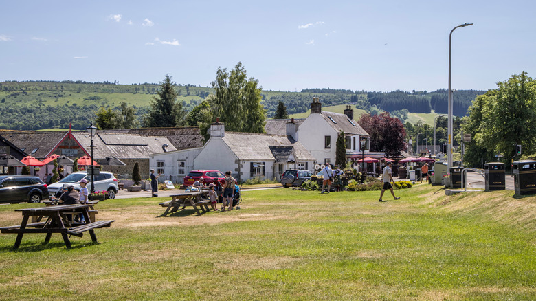 Village buildings in Drumnadrochit, Scotland with hills in distance