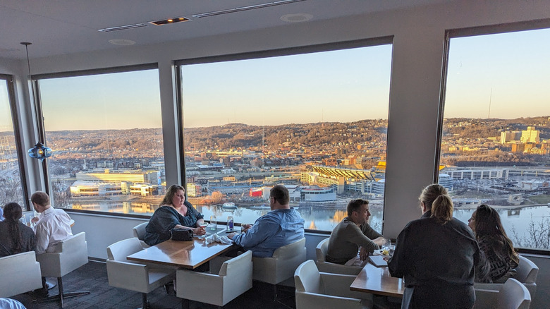 Tables at Altius, with Pittsburgh's skyline out the window