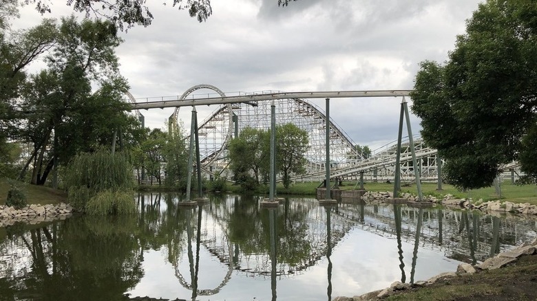 A lake with roller coasters in the background at Adventureland