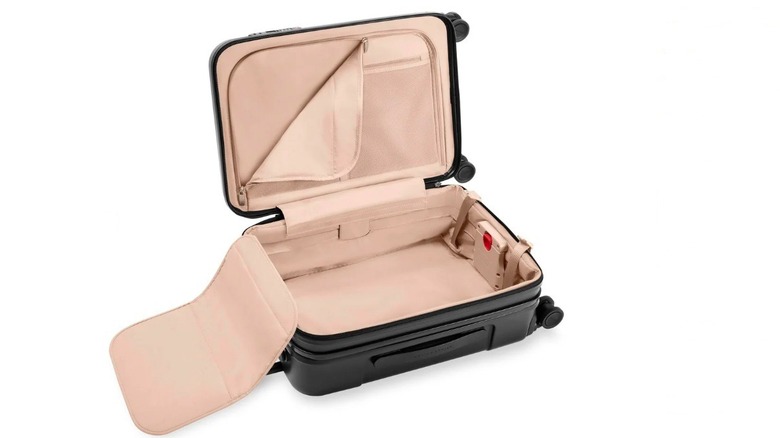 The interior of the Briggs & Riley Sympatico Essential 22-inch Carry-On Expandable Spinner suitcase in black.