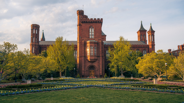 A view across the National Mall in D.C. at a brick castle-like Smithsonian Institution building