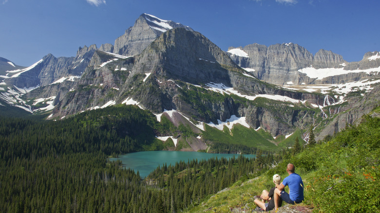 A couple alone out in the rugged nature taking in the view of Glacier National Park in Montana